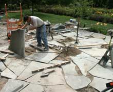 Stone mason Alex laying stone